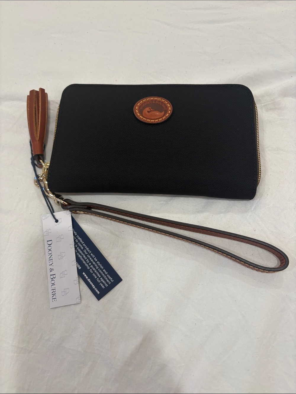 Dooney & Bourke Black Wristlet with Brown Leather Trim and Tassel